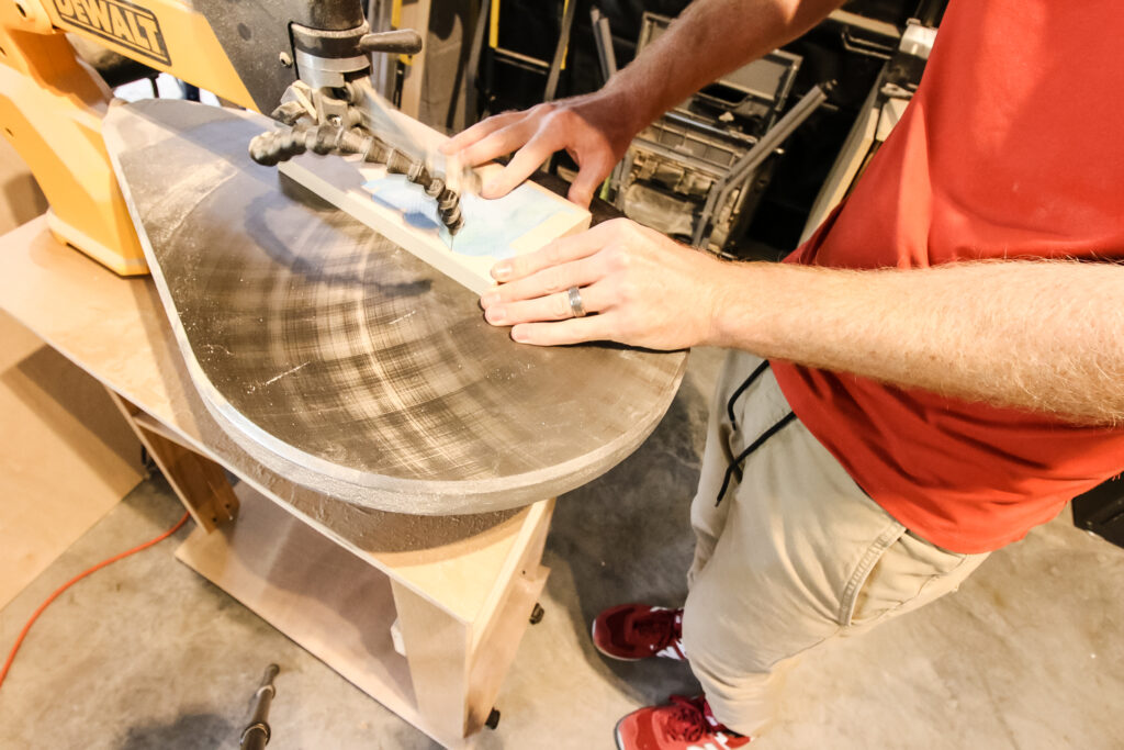 Cutting wooden lacing toy out with scroll saw