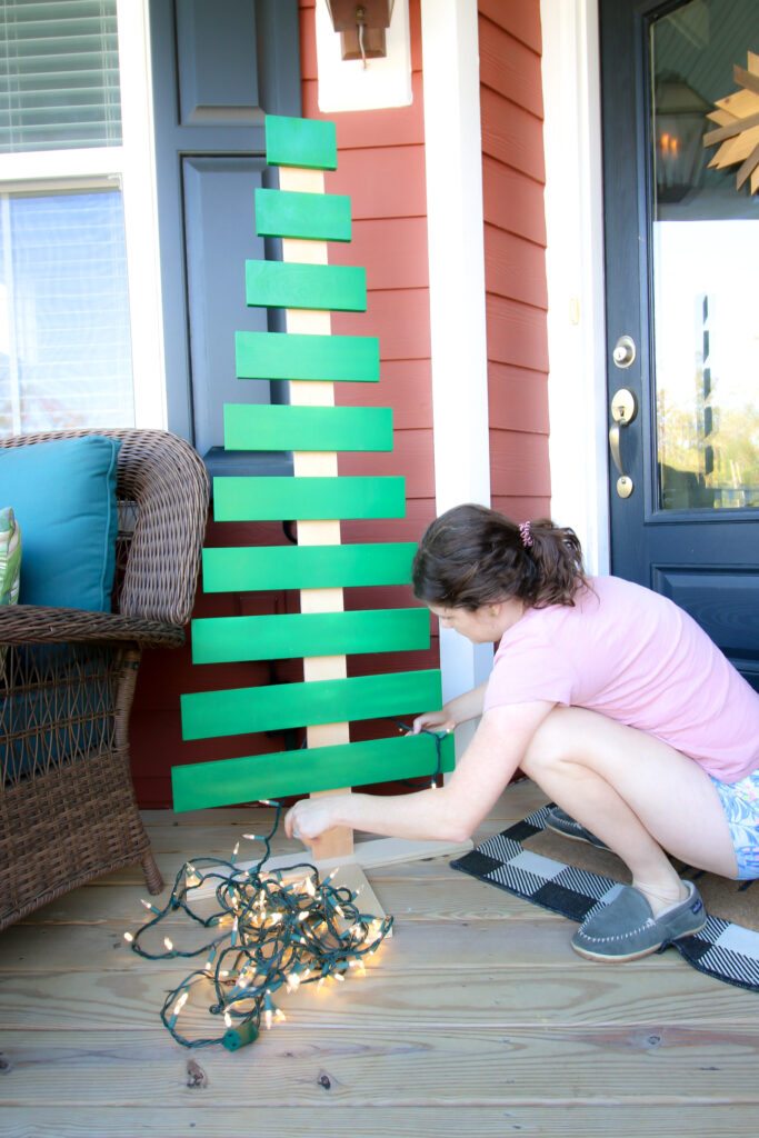 Hanging Christmas lights on DIY wooden Christmas tree