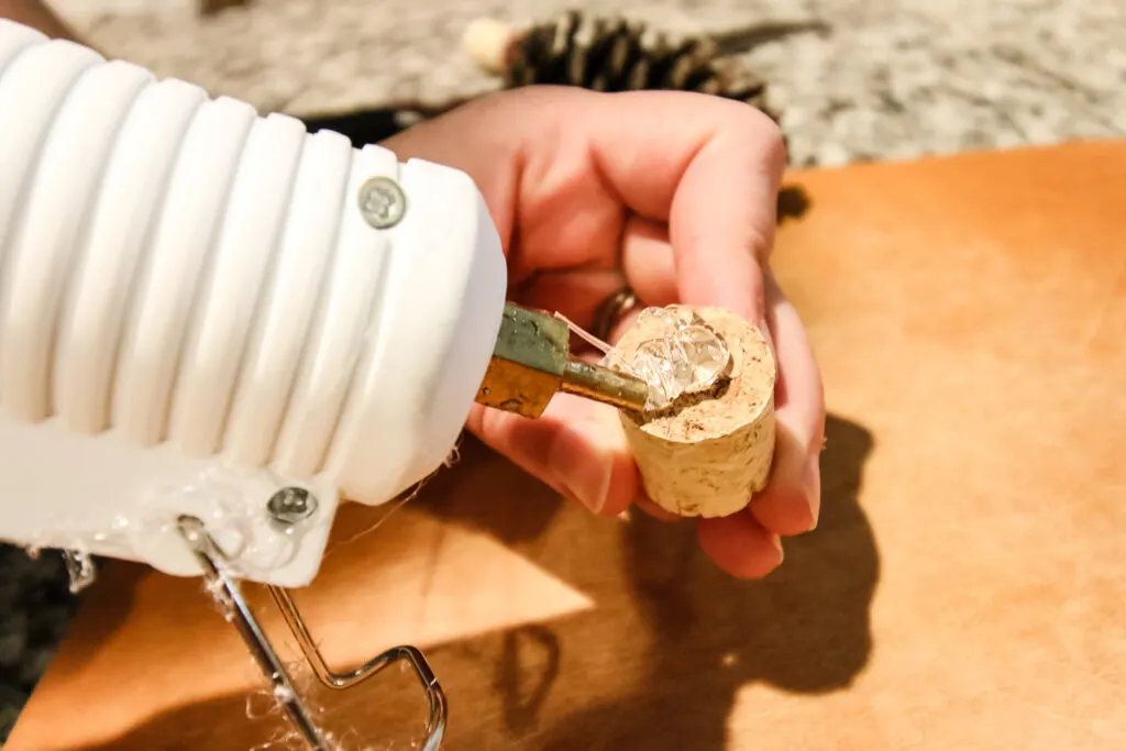 putting hot glue on a cork