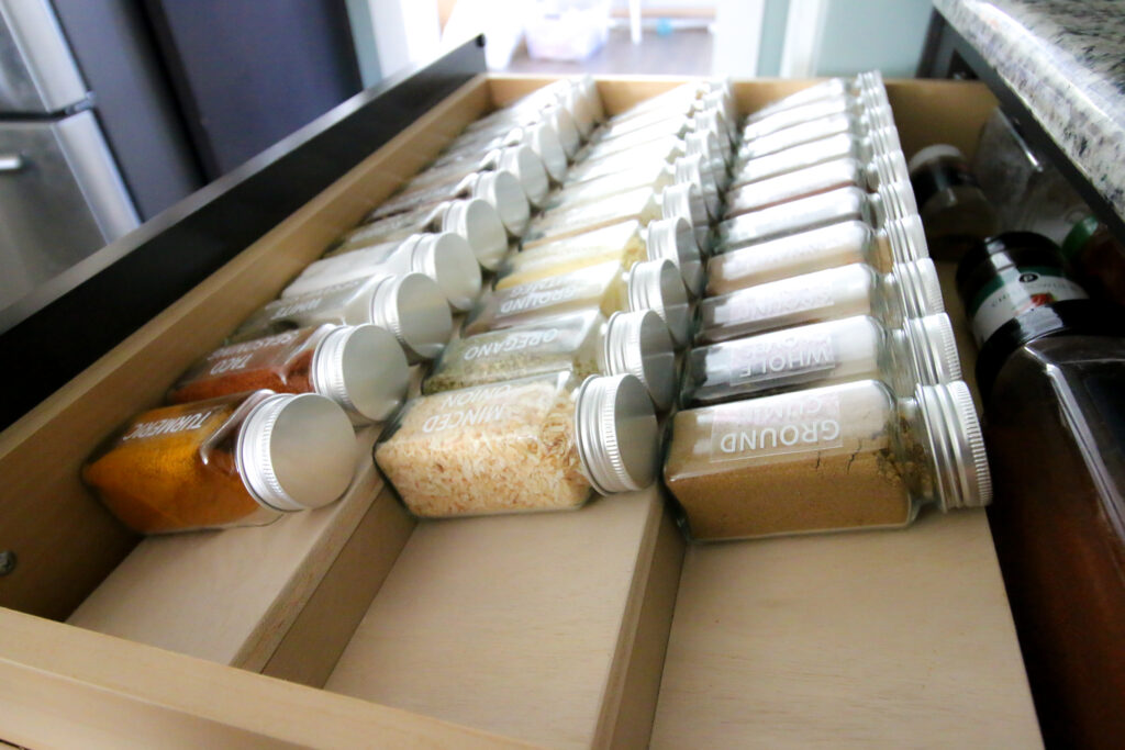 Spices organized on tiered spice drawer organizer
