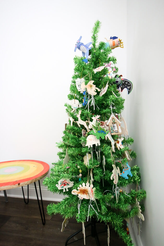 christmas tree covered with mini wooden kids homemade ornaments