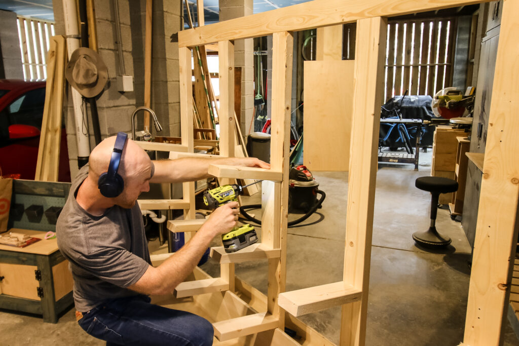 Attaching angled racks to vertical posts for scrap wood board storage