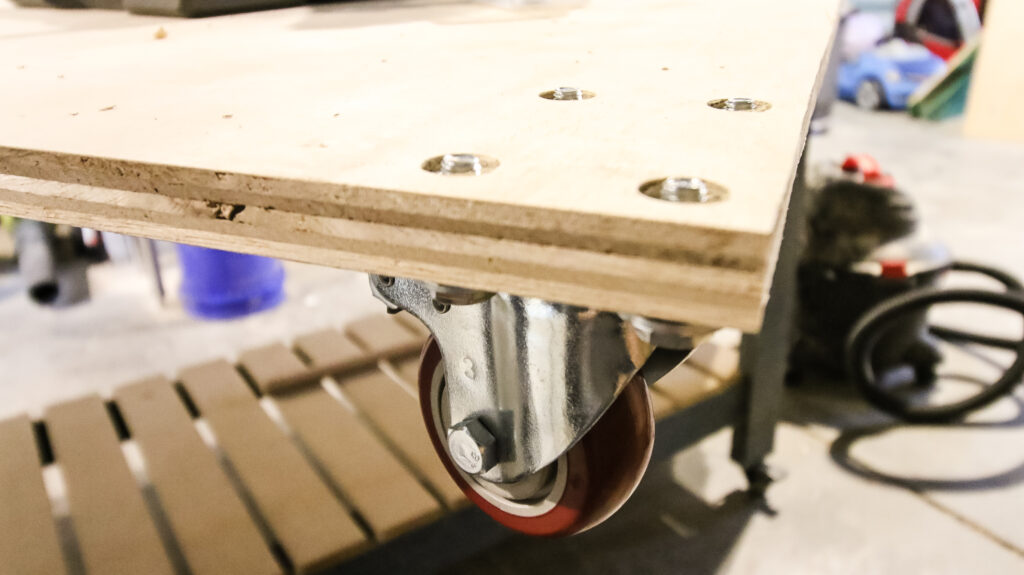 Rolling casters on base of scrap wood storage cart