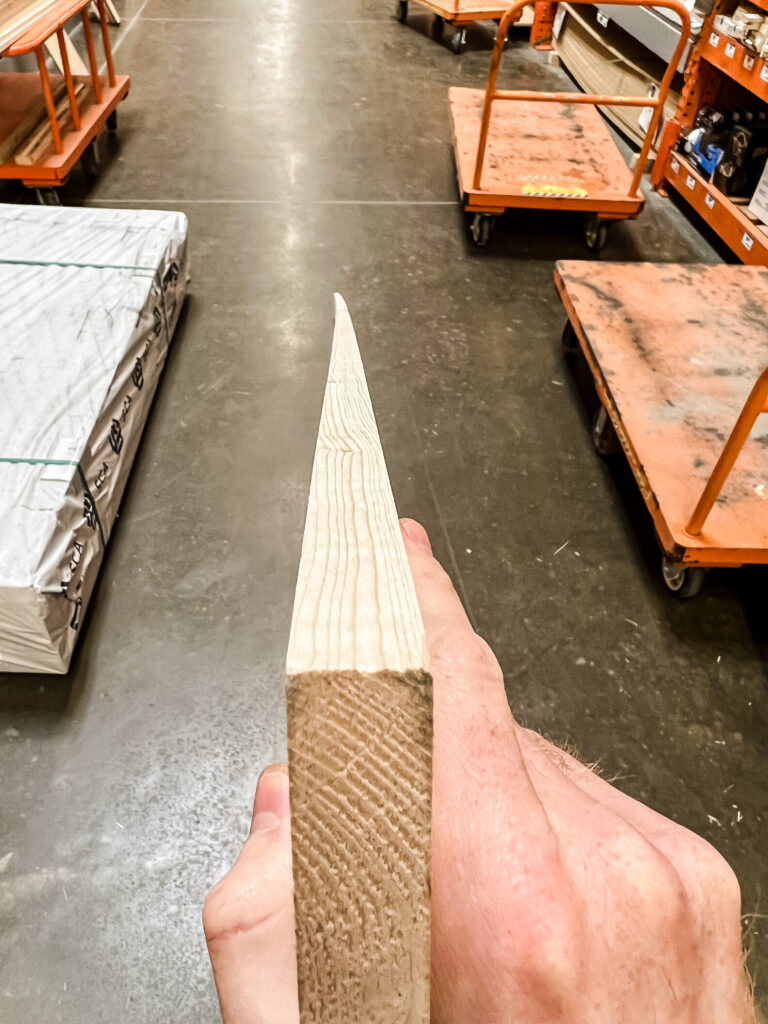 Looking down length of lumber board when shopping