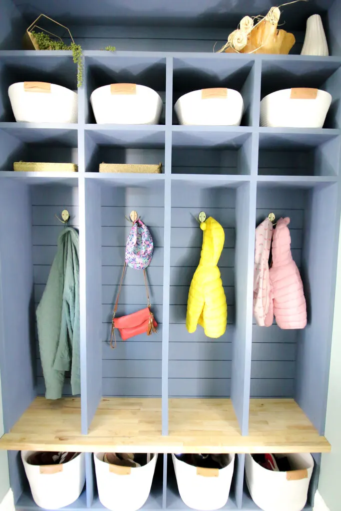 DIY mudroom lockers filled with jackets and bins