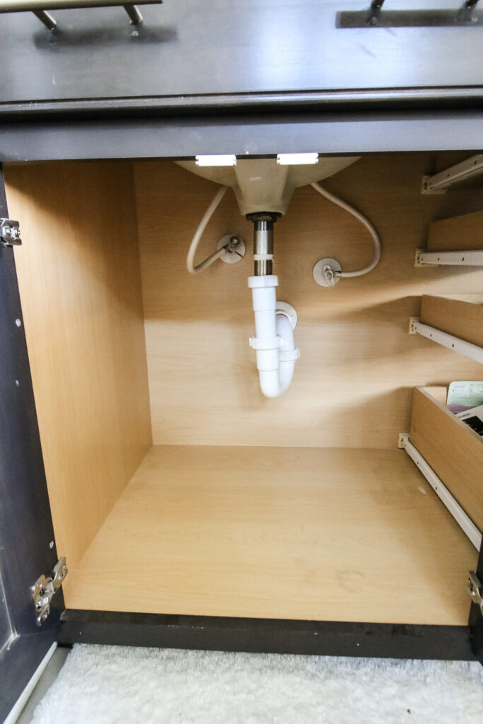 empty cabinet under a bathroom sink