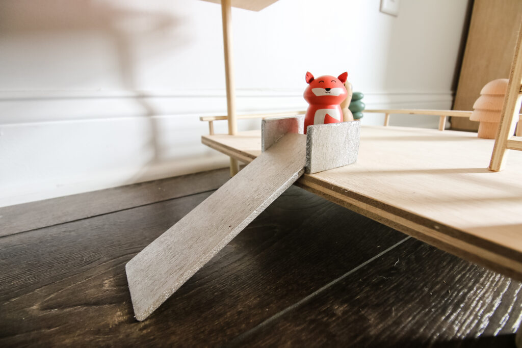 Slide on wooden toy treehouse