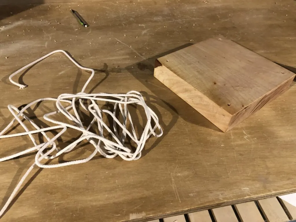 Board with rope for hanging plant shelf