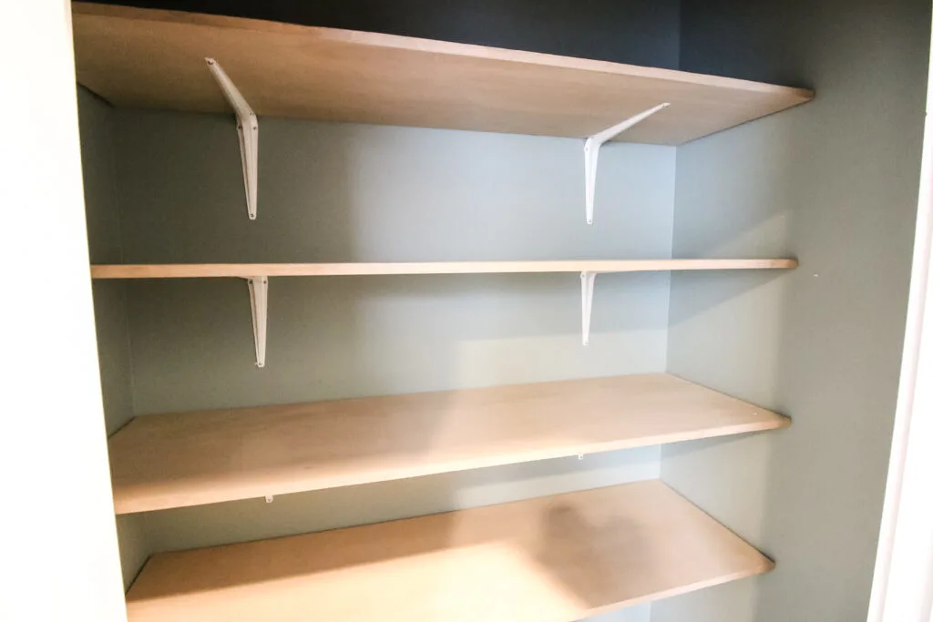 DIY linen closet shelves with space between them
