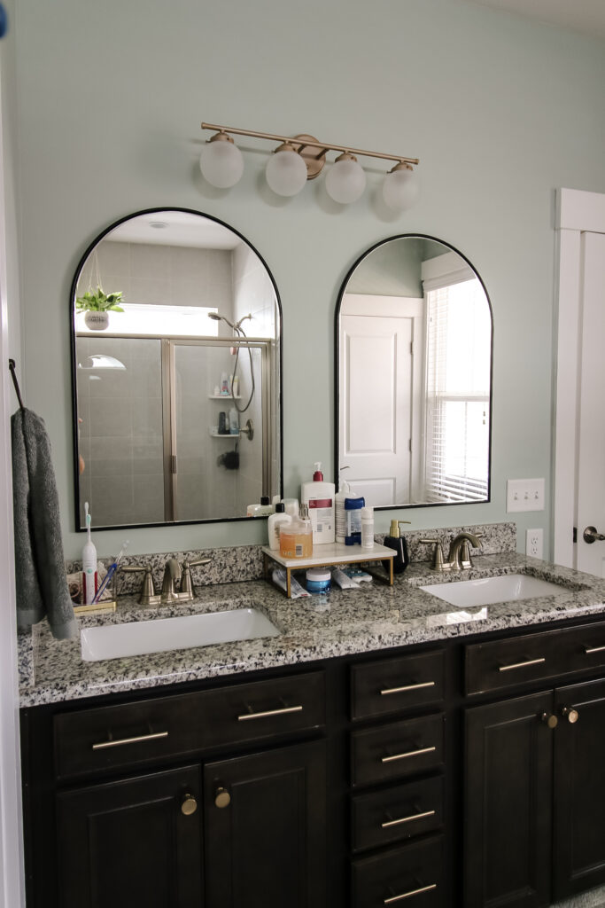 Arched mirrors and new bathroom vanity light in bathroom