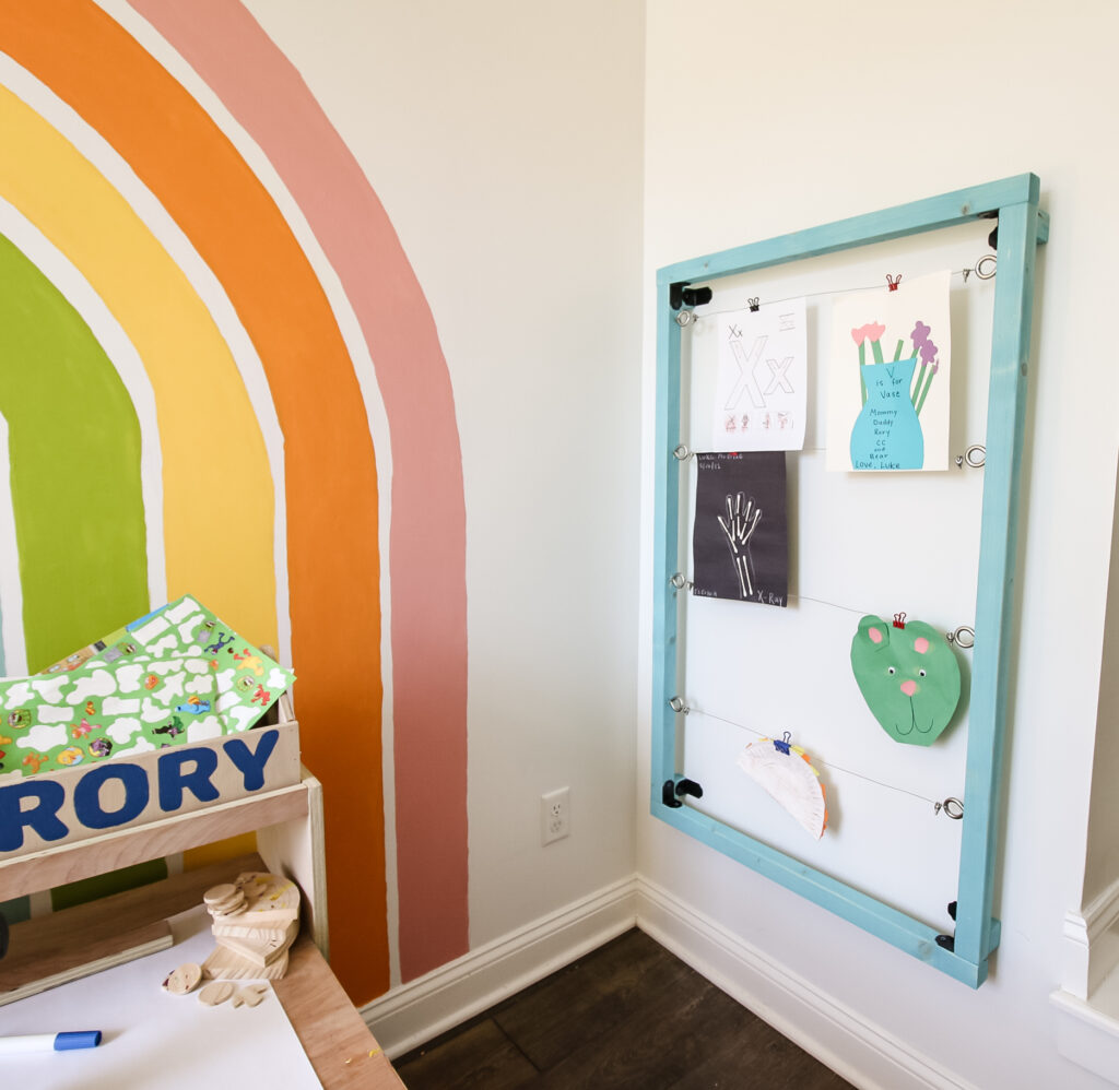 Kids art display with rainbow mural