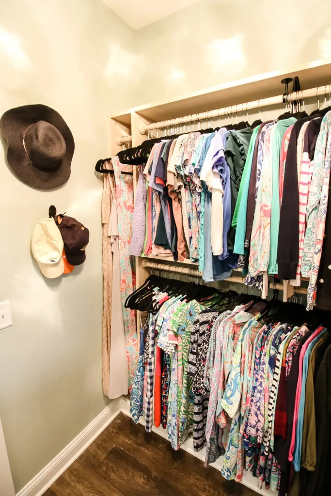 Custom built in hanging clothes storage in walk in closet