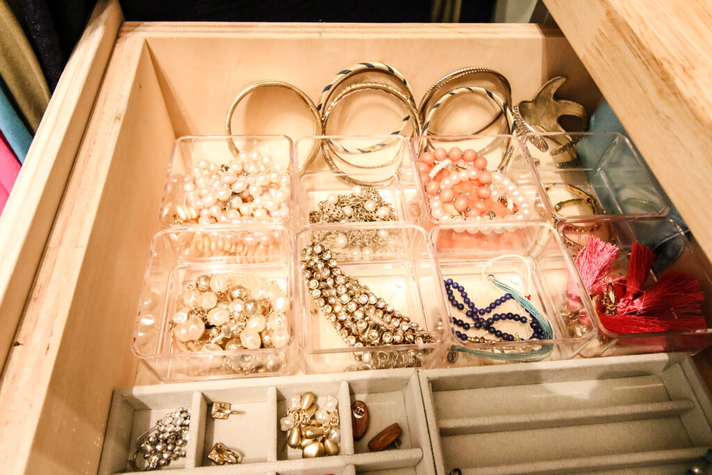 bracelets in small containers in a drawer