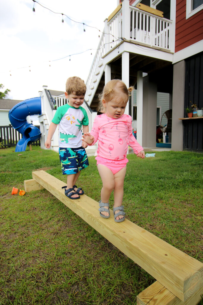 Toddlers walking on DIY balance beam