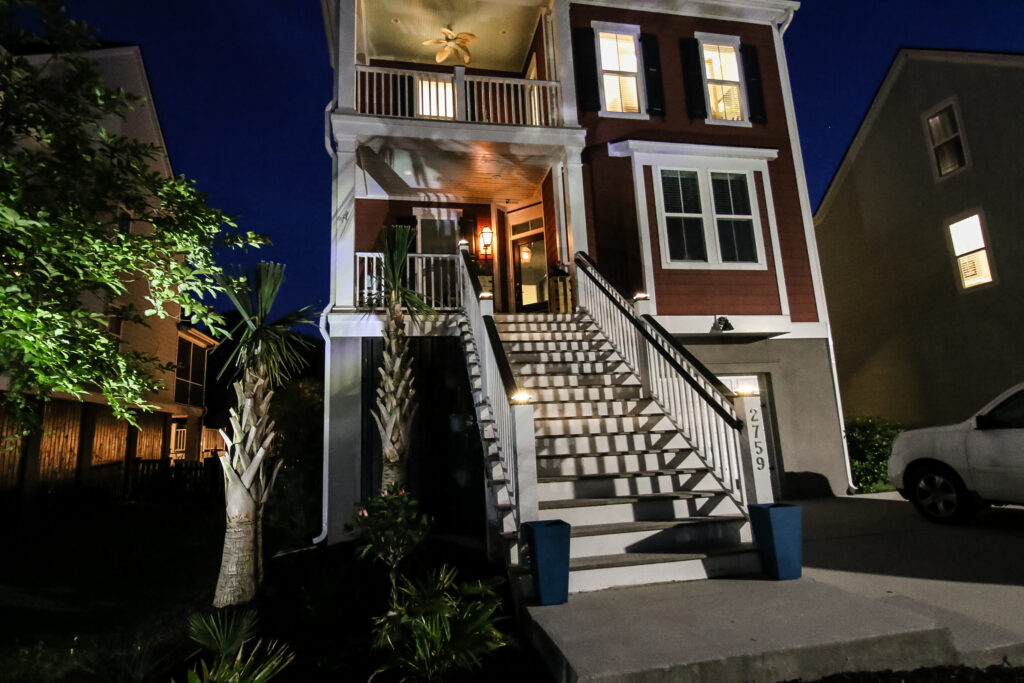 Solar post cap lights on stairs with solar lights aimed at palm trees