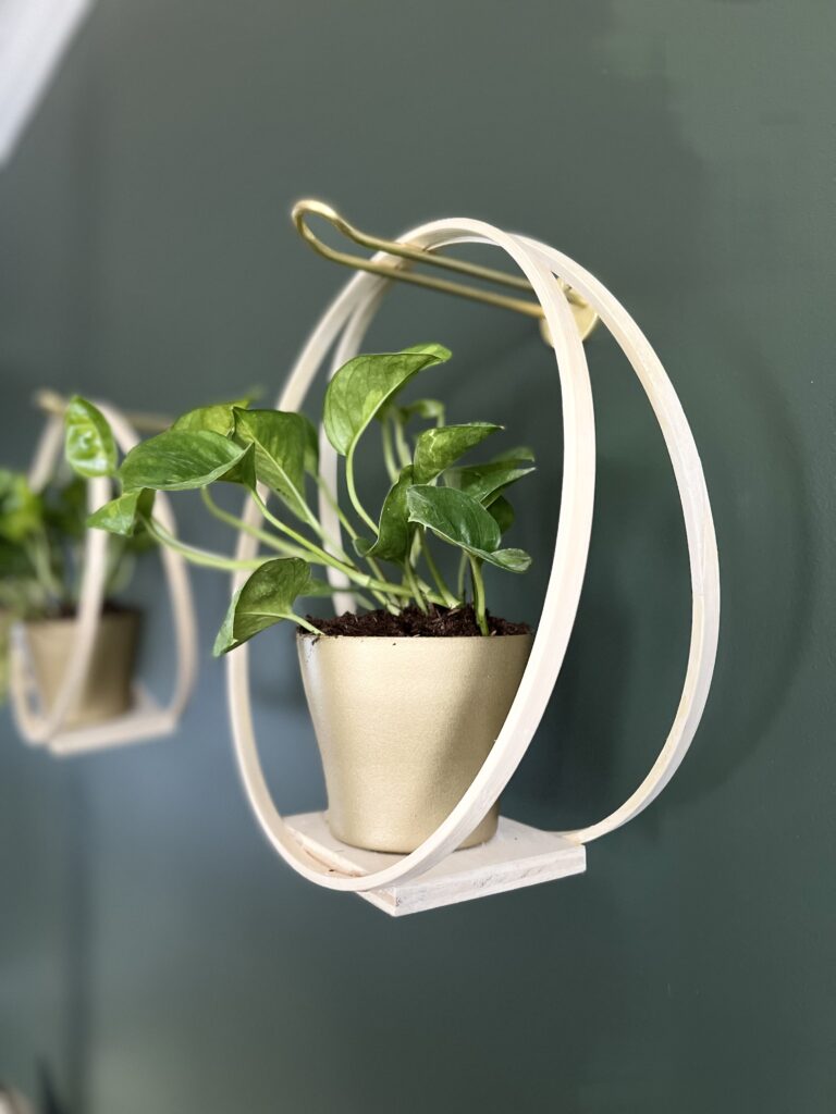 three wooden hoop hangers hanging on a wall