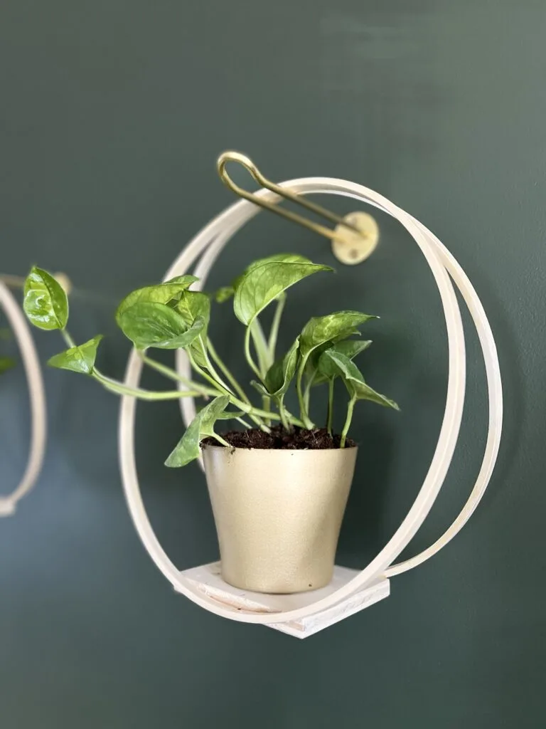 three wooden hoop hangers hanging on a wall