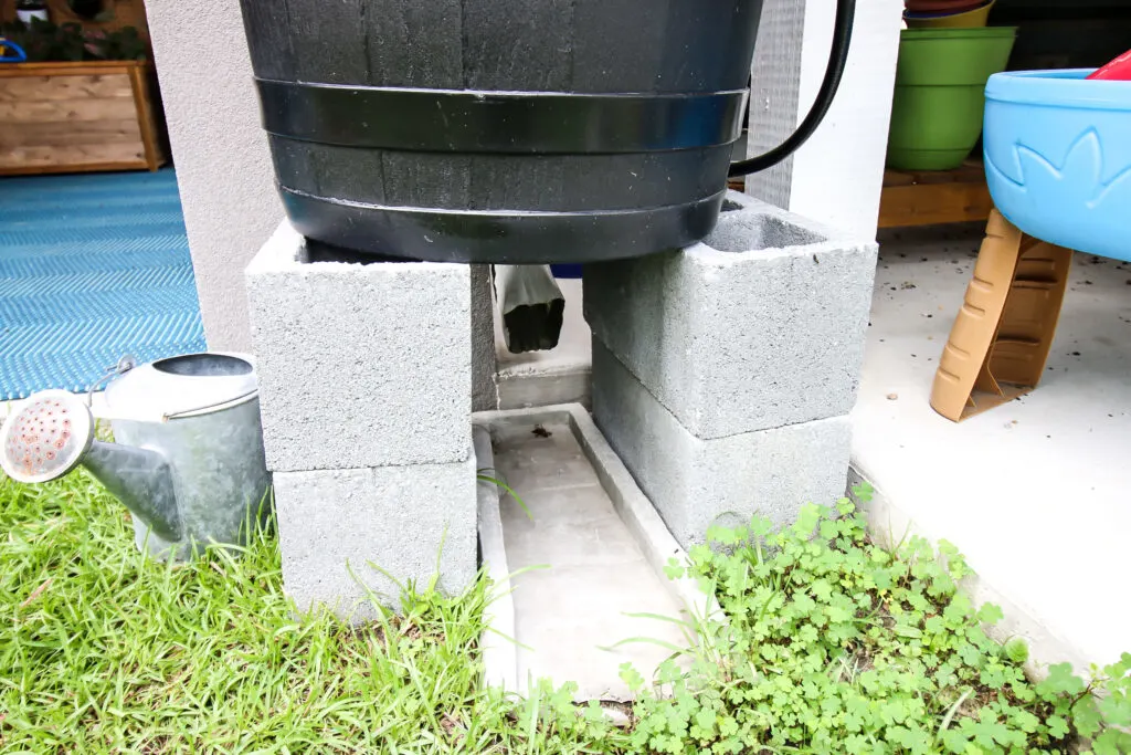 bottom of rain barrel with downspout underneath