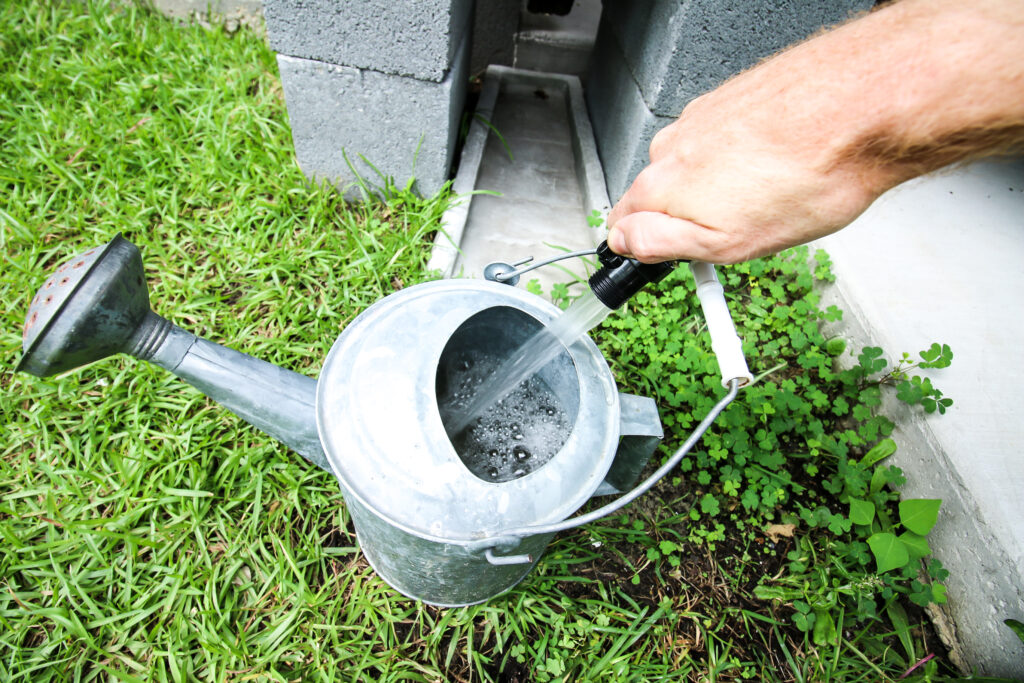 rain barrel filling a watering can