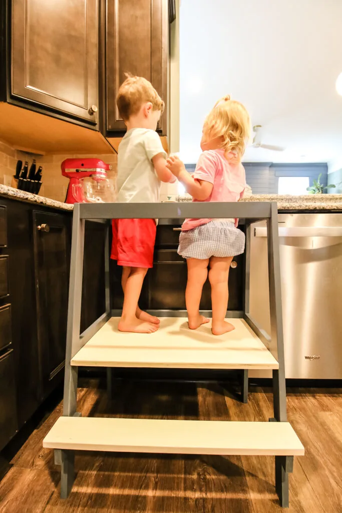 Toddlers standing on DIY kids learning tower
