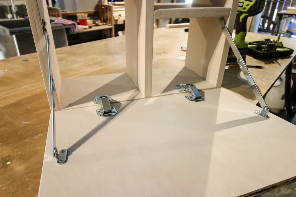 Folding arms attached to vanity