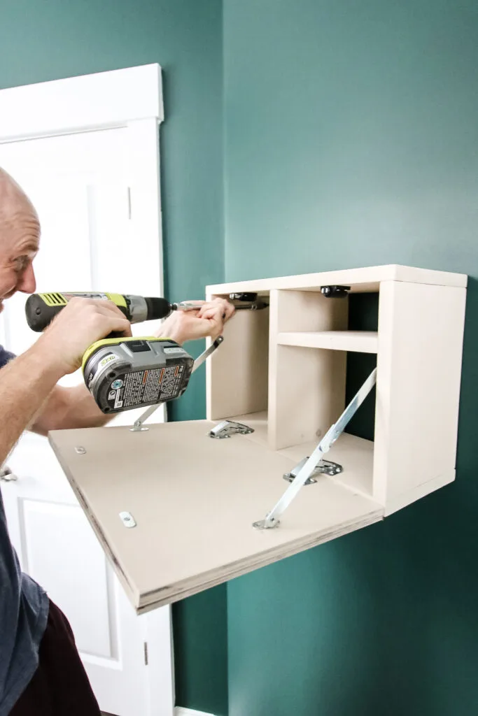 Attaching fold down vanity to wall