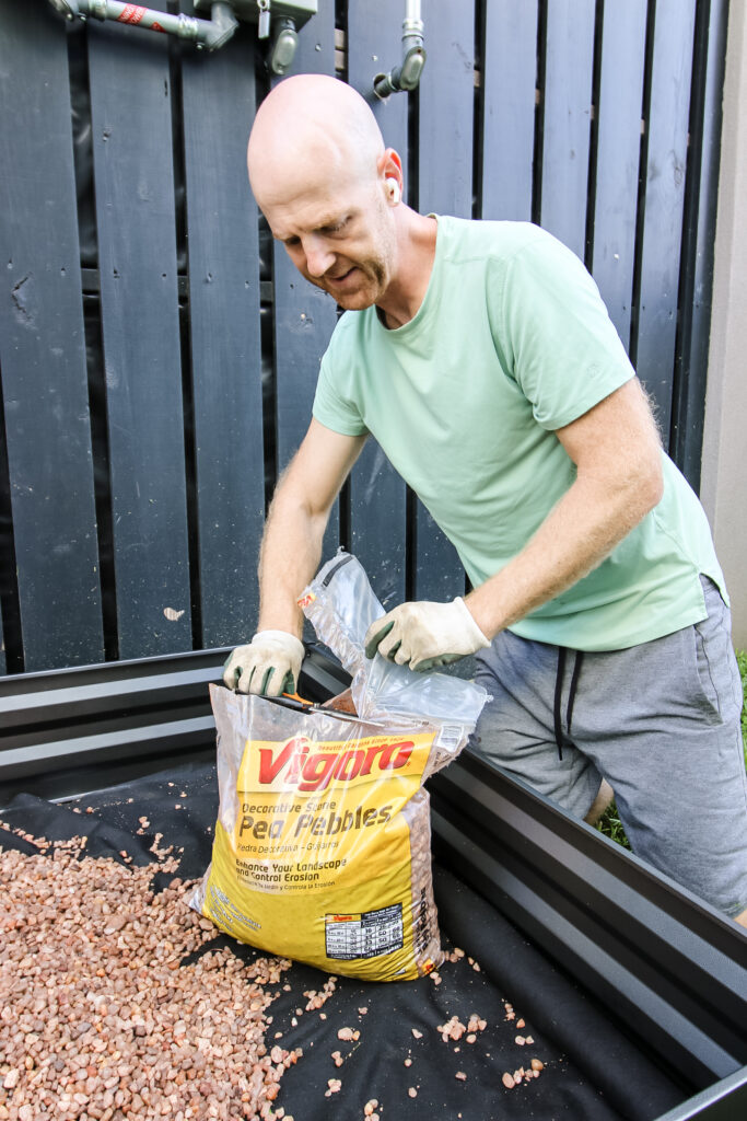 Placing Vigoro rocks in garden bed