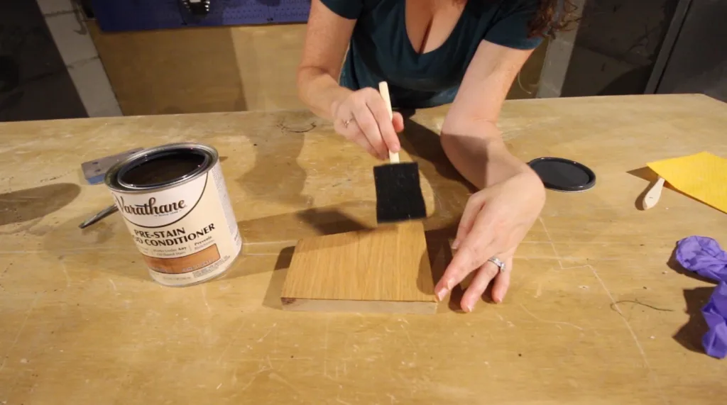 applying wood conditioner to oak wood