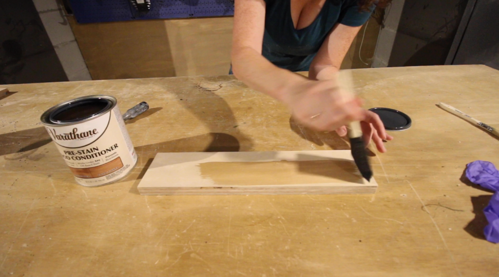 applying wood conditioner to plywood