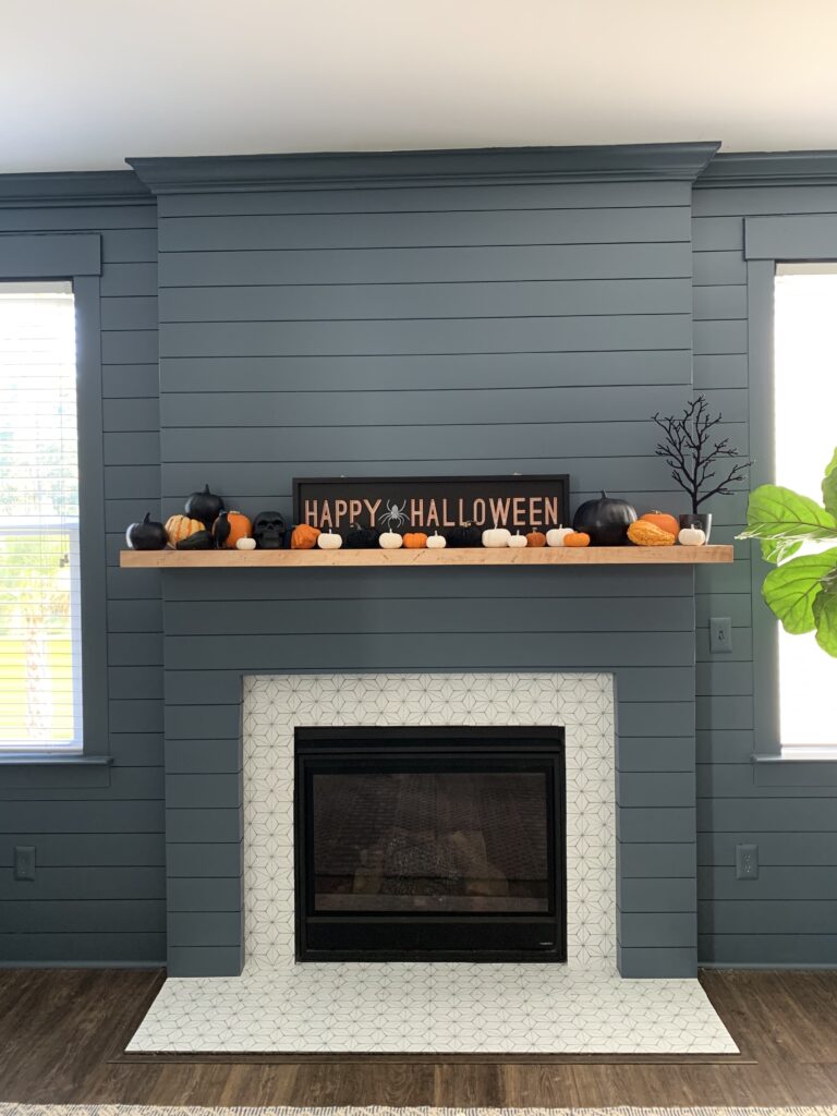 fireplace with halloween pumpkins on the mantel