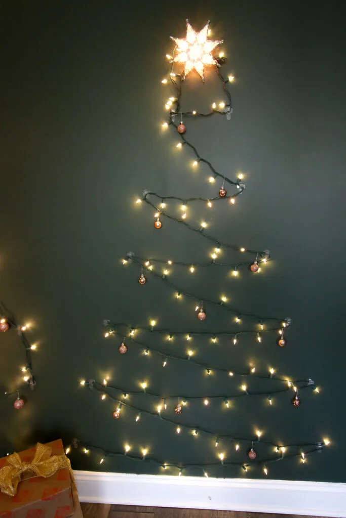 Christmas tree made from lights on the wall of a room