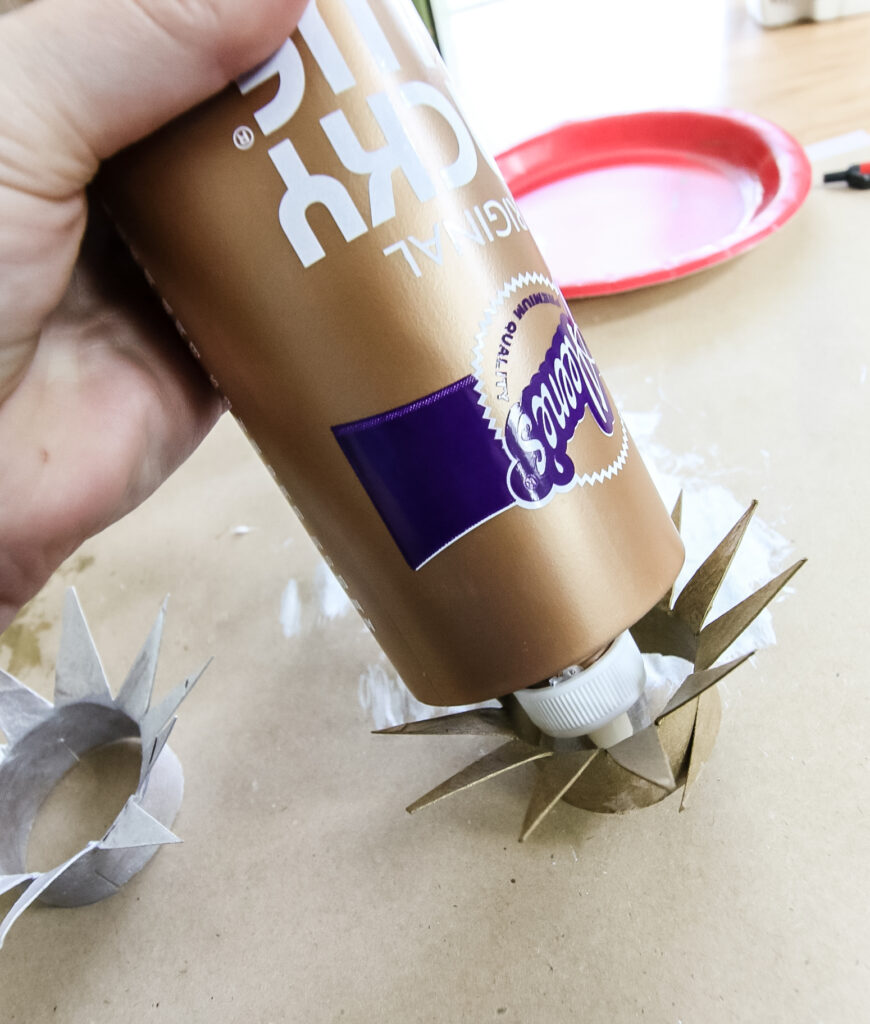 gluing toilet paper roll ornaments