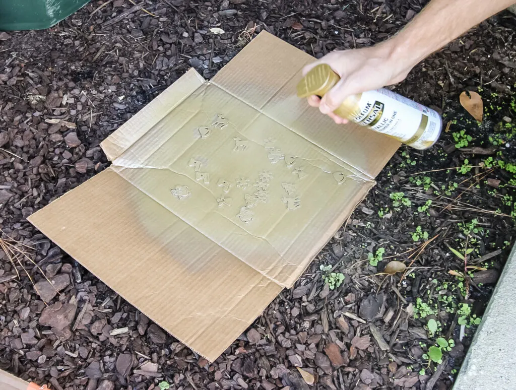 Spray painting ornaments for card holder