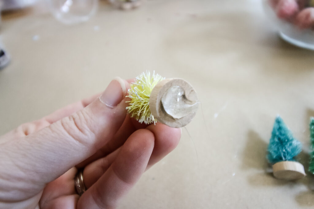 hot glue on the bottom of a bottle brush tree