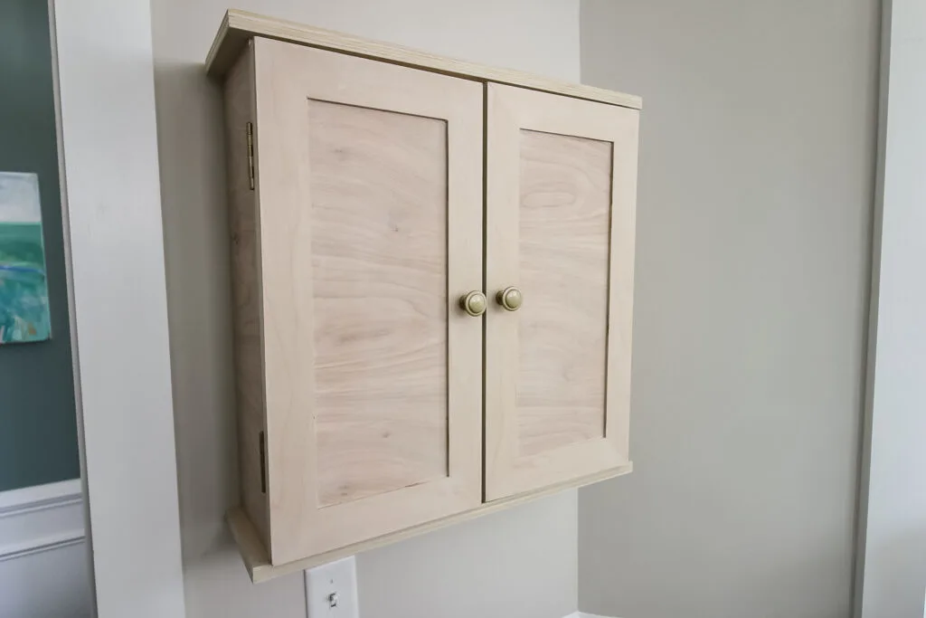 DIY dartboard cabinet hung on wall