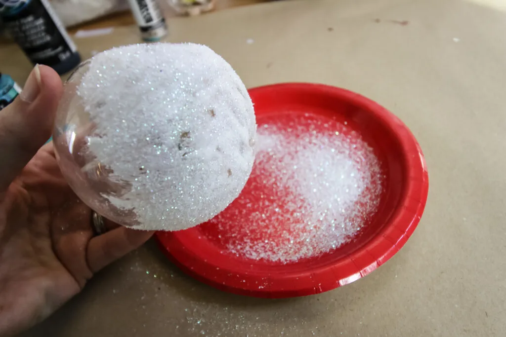 adding glitter to an ornament ball