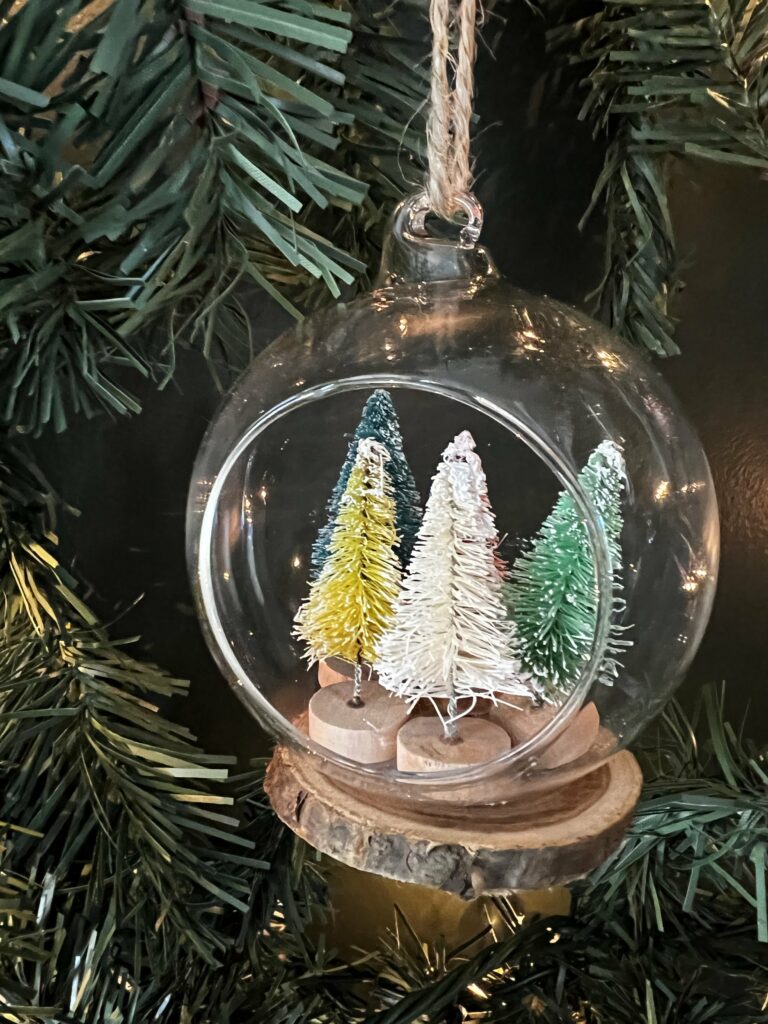 bottle brush christmas tree ornament in a clear terrarium ornament ball