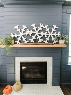 DIY wooden snowflakes above fireplace