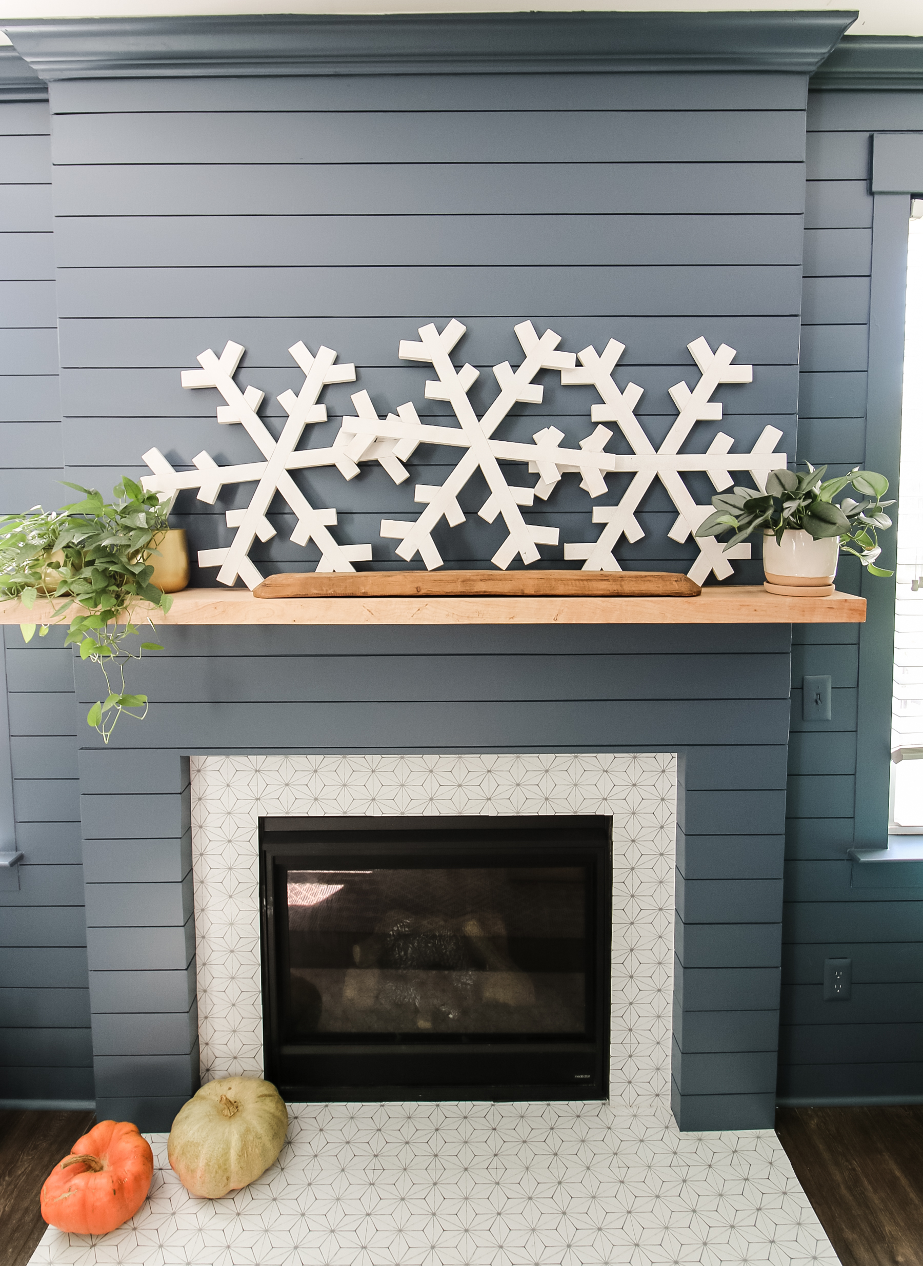 DIY wooden snowflakes above fireplace
