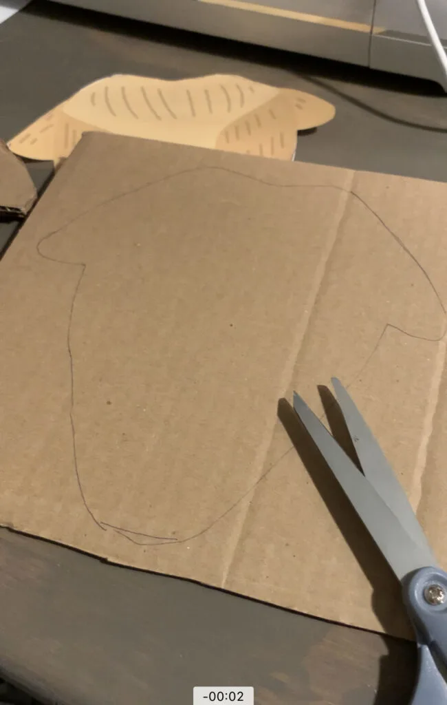 cutting out reindeer head from cardboard