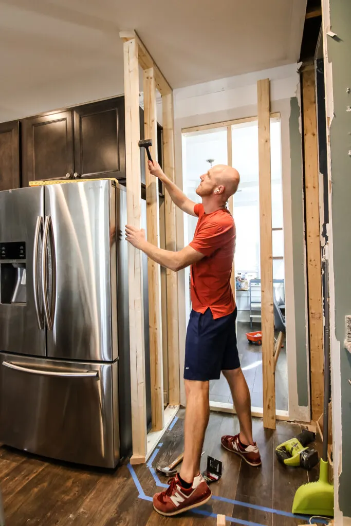 Hammering walls into place for new pantry