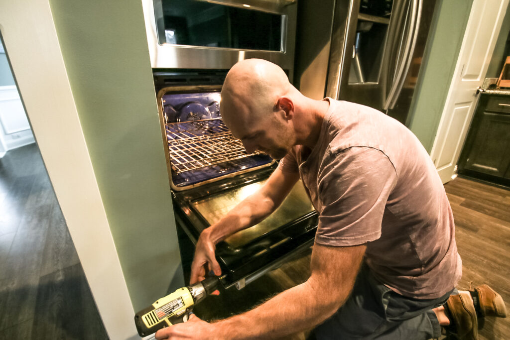 Remove screws on oven door