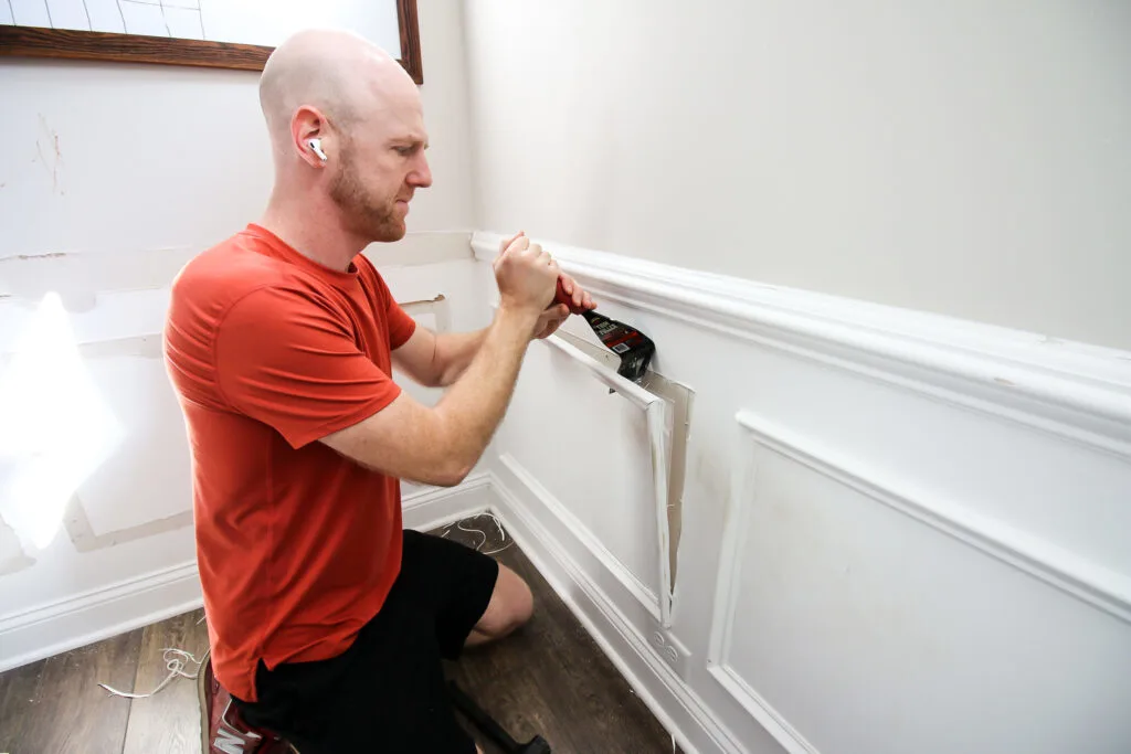 Prying wainscoting off wall with trim puller