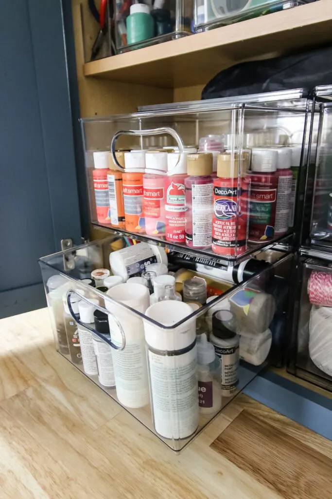 pull out drawer of craft supplies in a cabinet