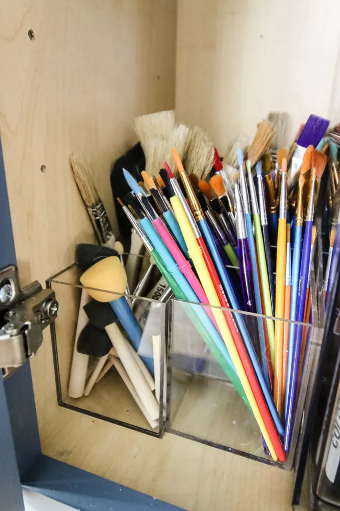 paint brushes sorted in a craft cabinet