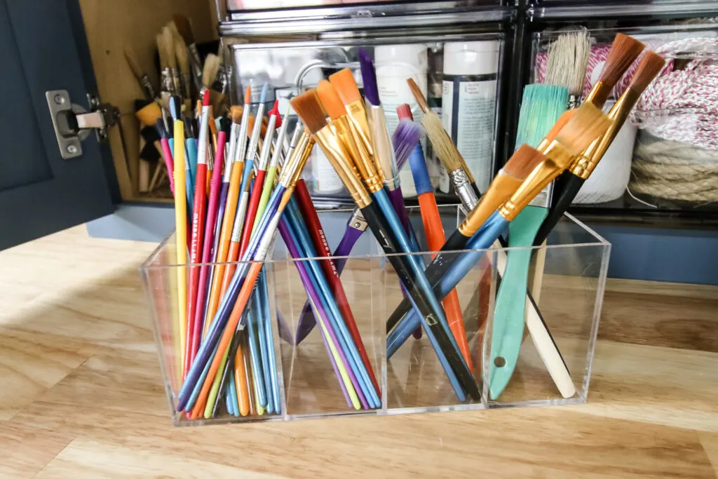 paint brushes sorted in a craft cabinet