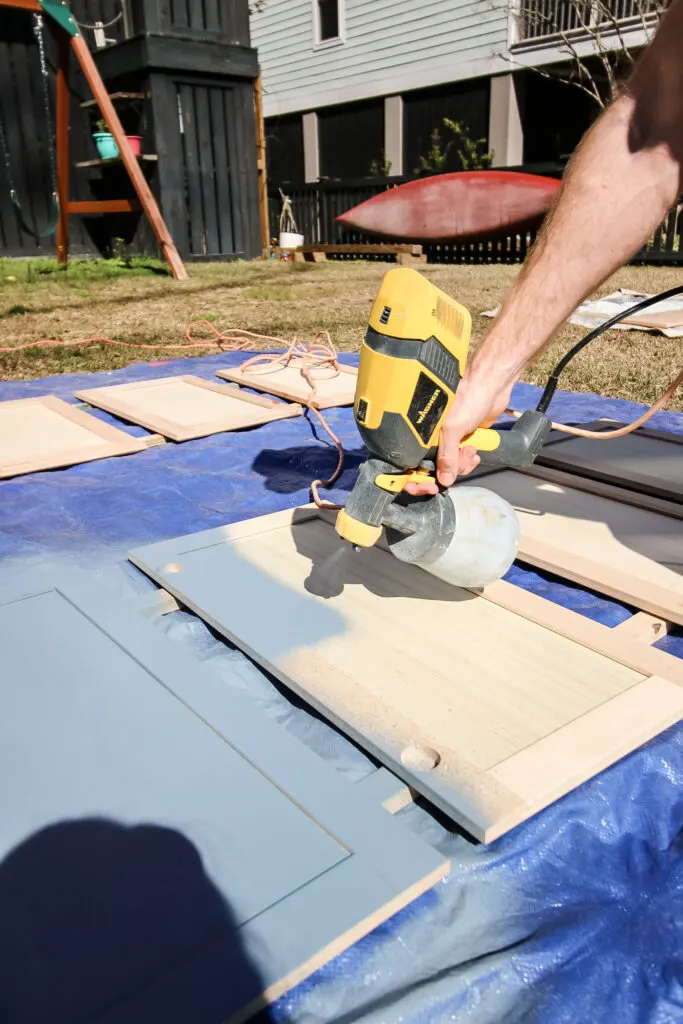 using a paint sprayer to paint cabinet doors