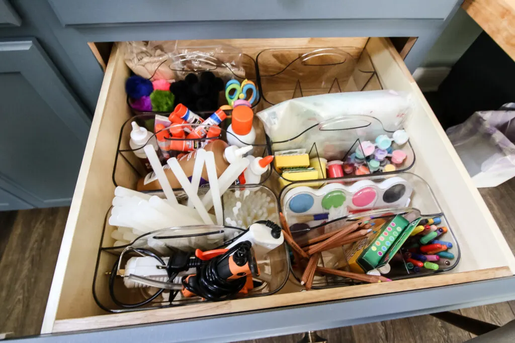 caddies of craft supplies in a drawer