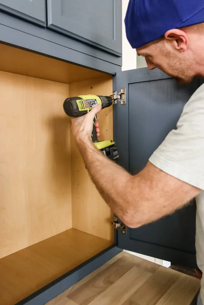 use drill to reattach cabinet doors