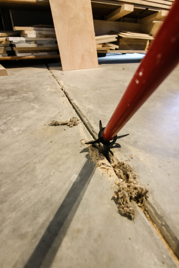 Pulling Zenith Crack and Crevice Cleaner in concrete garage expansion joints
